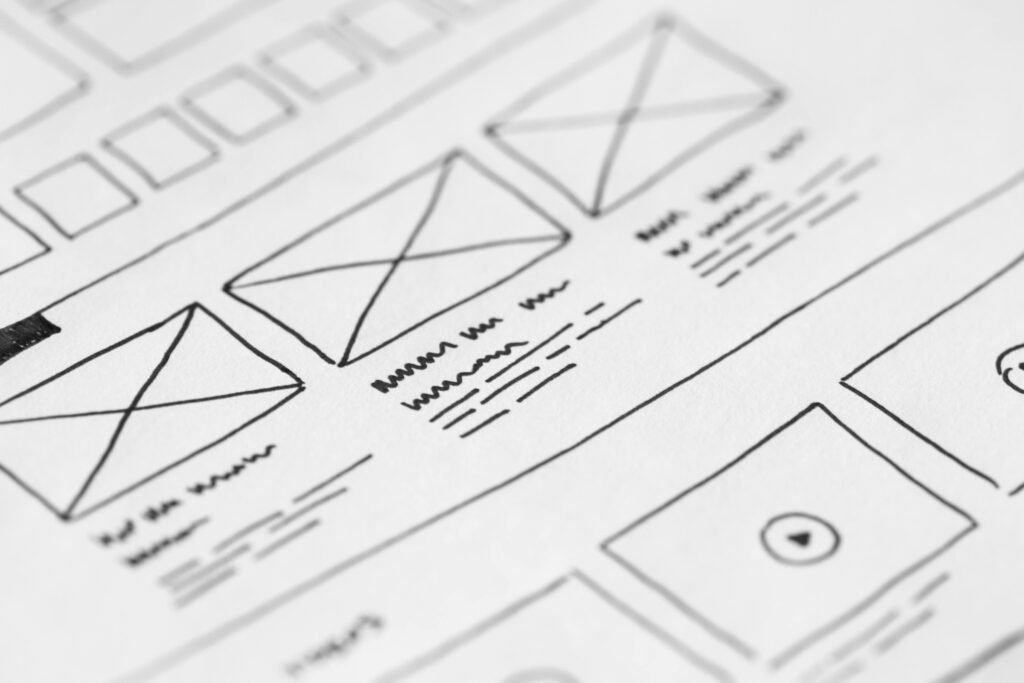 Wireframe sketch of a website layout illustrating UX design elements, with placeholder images, text blocks, and navigation—highlighting common UX mistakes.